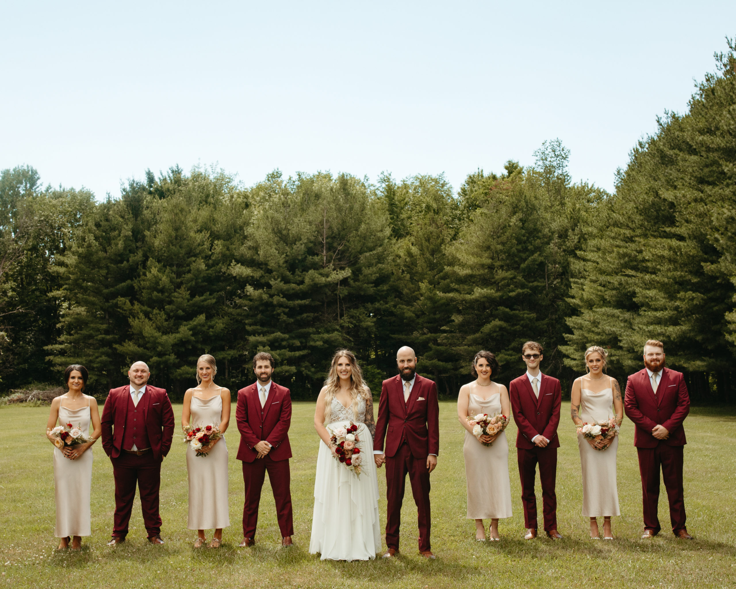 bridal party portrait with burgundy and champagne color palette 