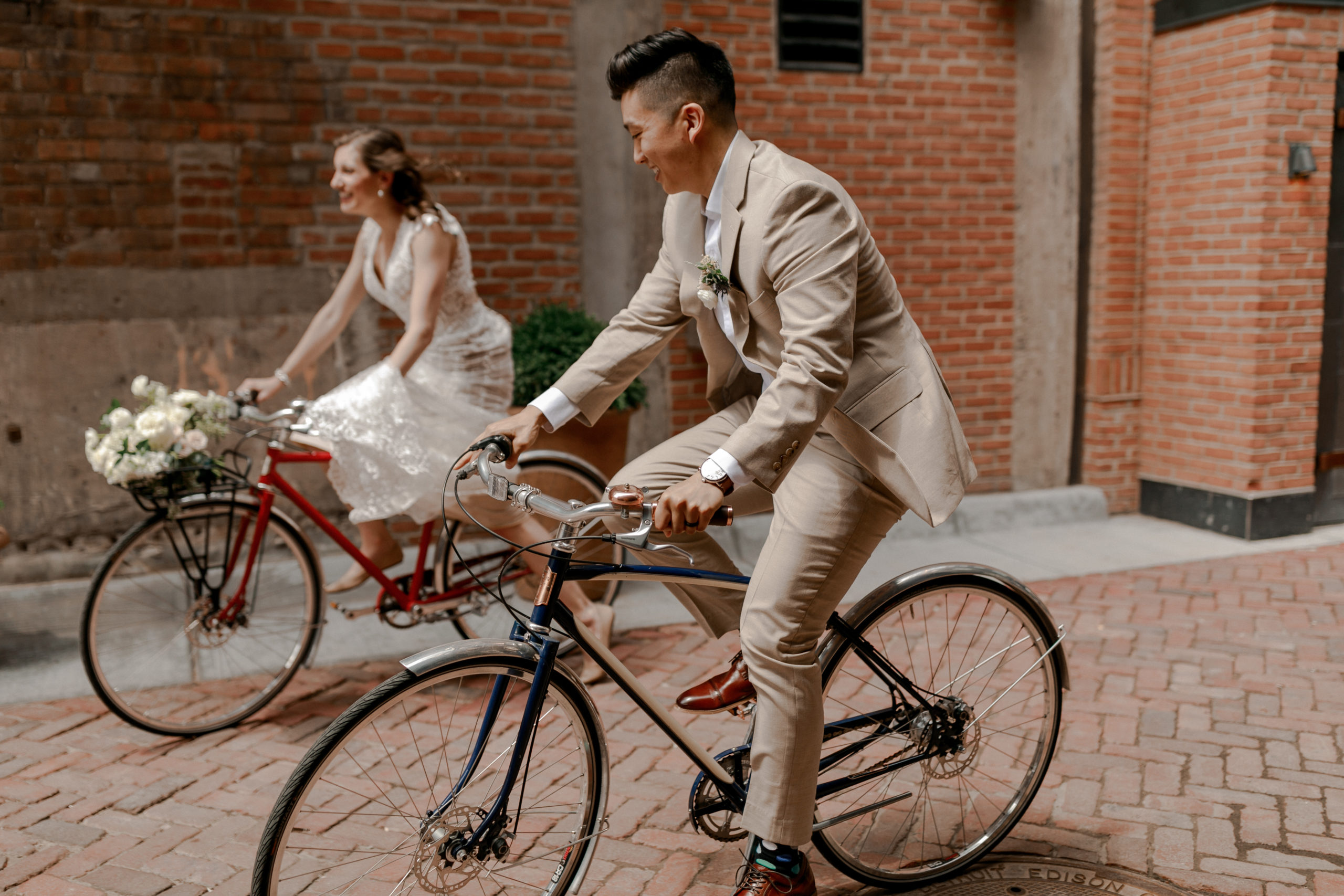 bride and groom riding bikes in Detroit